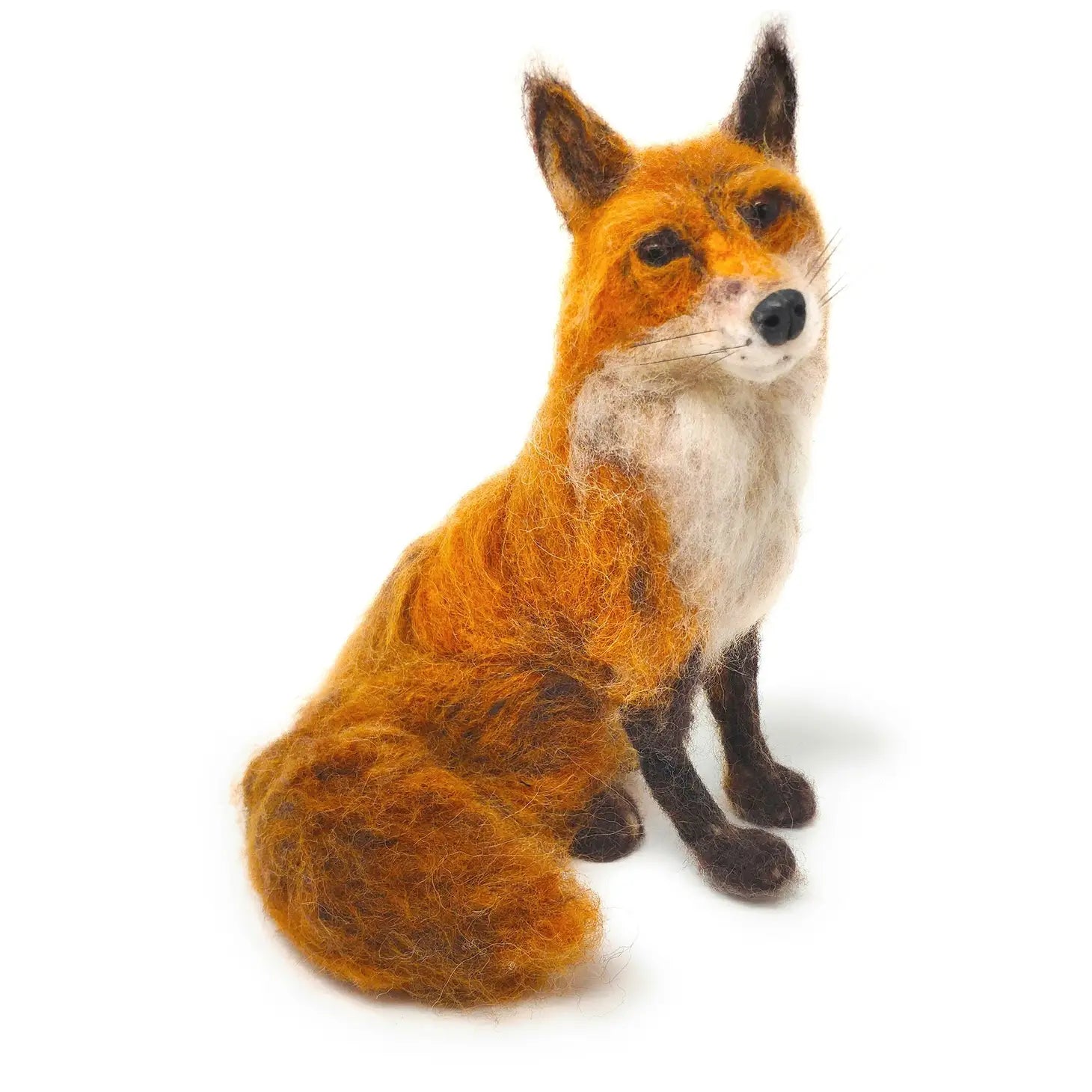 The Crafty Kit Company Fabulous Felt Foxy is a felted wool fox sculpture, crafted from Corriedale wool, featuring a bushy tail. It sits and looks forward on a white background, making it perfect for those who enjoy the Needle Felting Craft Kit experience. Meet Mr Foxy!