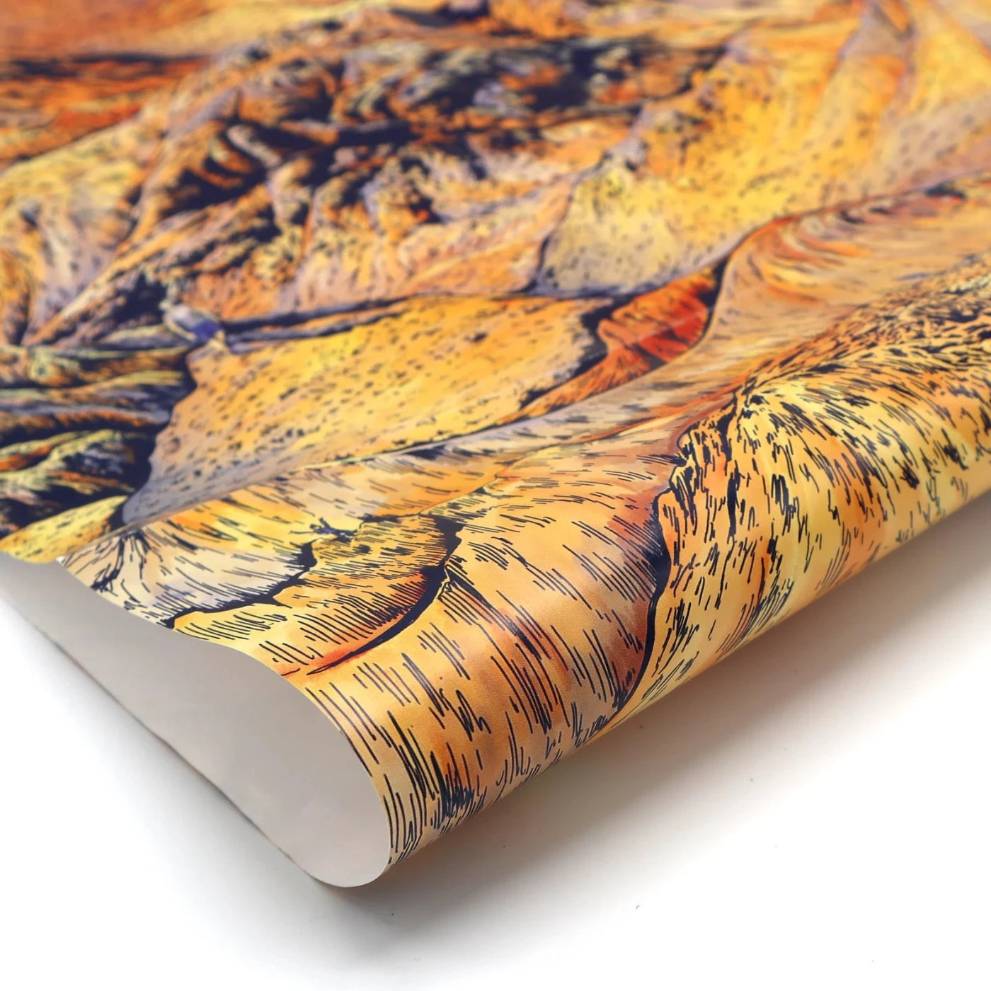 Image shows one sheet of orange wrapping paper with an all over mountain print design with navy detailing