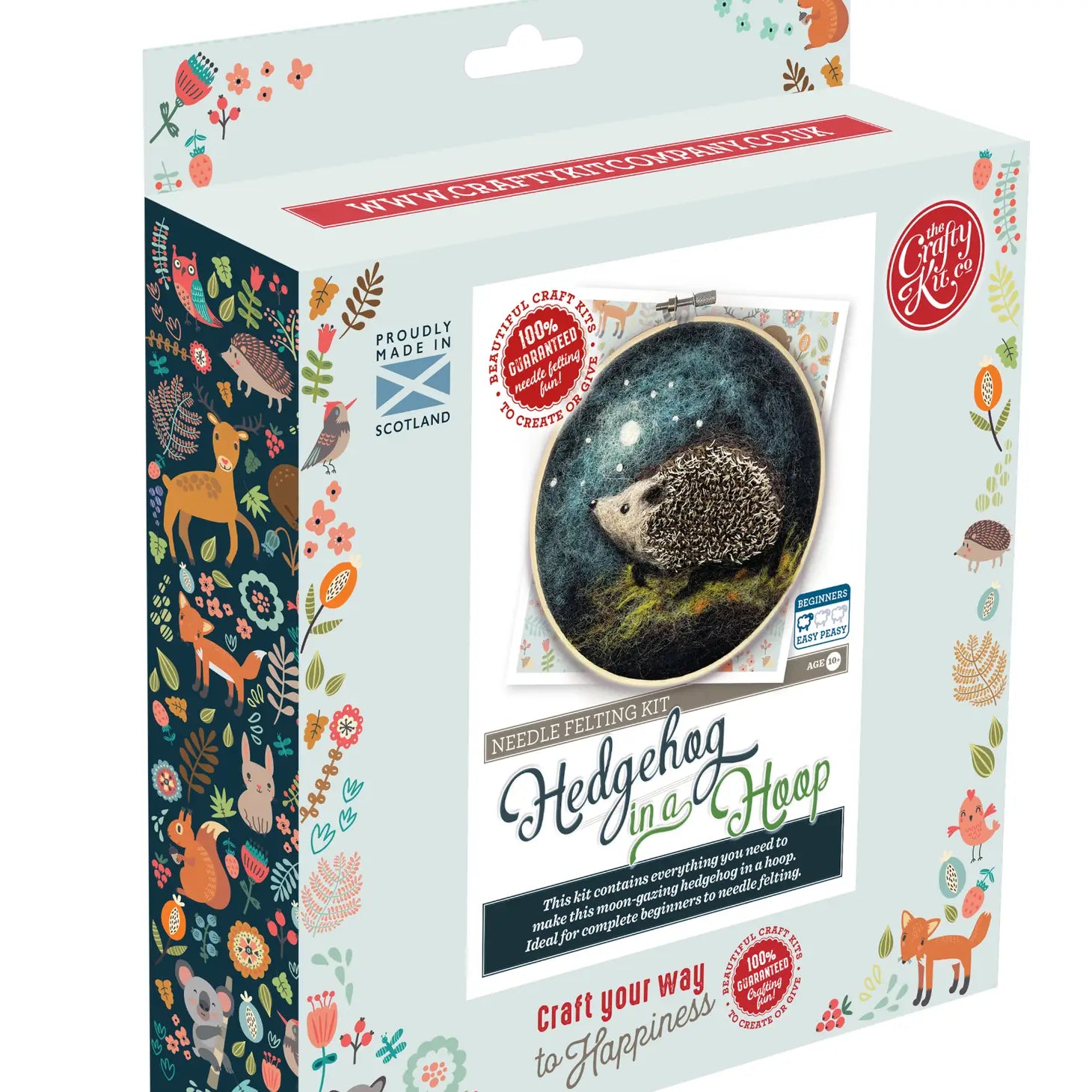 The Crafty Kit Company Hedgehog In A Hoop Needle Felting Craft Kit box features a charming hedgehog in a hoop design, lively patterns along the sides, and text that reads “Hedgehog In A Hoop” and “Craft your way to Happiness.” This kit is perfect for beginner crafters.