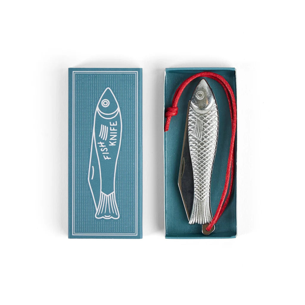 A Mollyjogger Fingerling Fish Knife Vegan Version (18+) featuring a fish-shaped design, stainless steel blade, and red vegan rope handle, nestled in a blue box adorned with a white fish illustration labeled "Fish Knife".